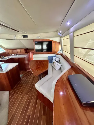  Yacht Photos Pics Luxurious interior of a 2007 Riviera 47 Convertible yacht with elegant wood finishes.