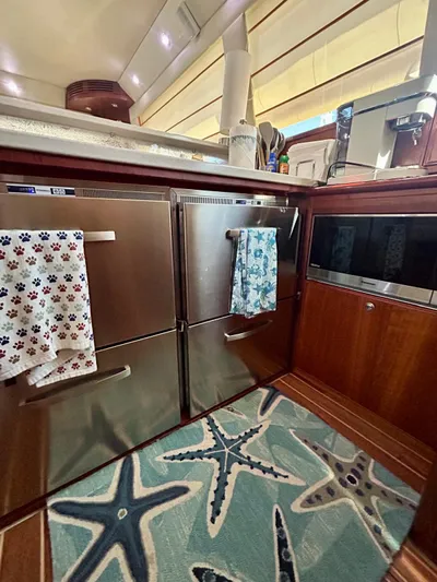 Yacht Photos Pics 2007 Riviera 47 Convertible yacht kitchen with stainless steel appliances and starfish-themed rug.