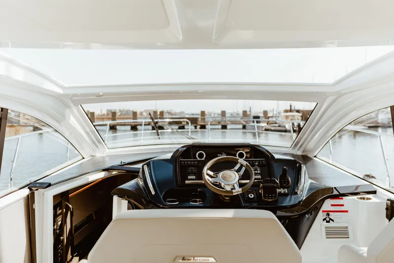  Yacht Photos Pics 2023 Beneteau Gran Turismo 41 yacht helm with modern controls and marina view.