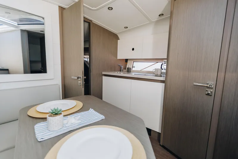  Yacht Photos Pics Interior of 2023 Beneteau Gran Turismo 41 yacht, featuring modern kitchen and dining area.