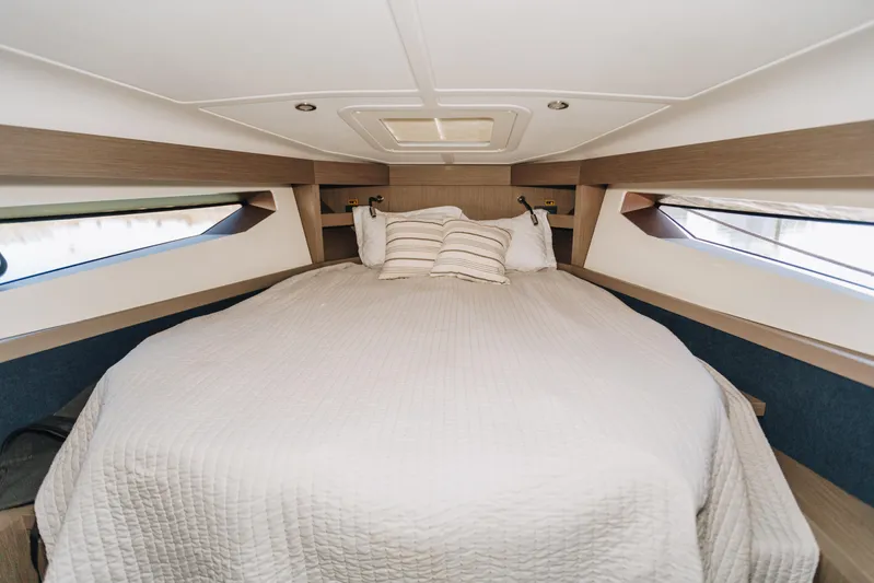  Yacht Photos Pics Luxurious cabin interior of 2023 Beneteau Gran Turismo 41 yacht with cozy bedding.