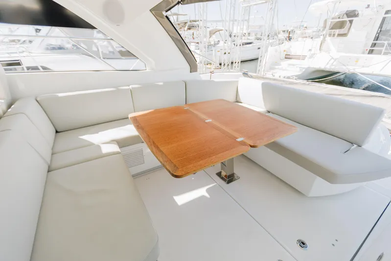  Yacht Photos Pics 2023 Beneteau Gran Turismo 41 yacht interior with elegant seating and wooden table.