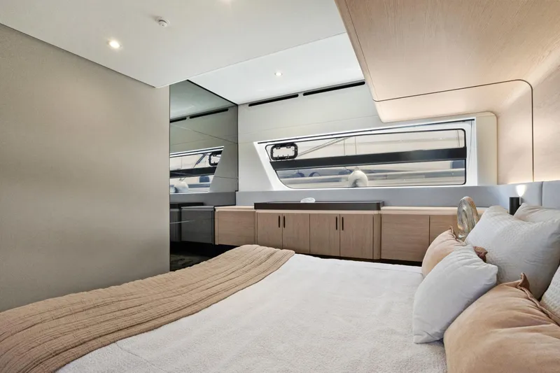 Guyal Yacht Photos Pics Luxurious bedroom interior of 2024 Azimut Fly 53 yacht, featuring modern design and elegant furnishings.
