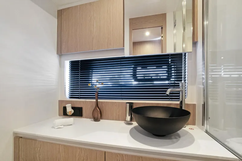 Guyal Yacht Photos Pics Modern bathroom interior of 2024 Azimut Fly 53 yacht with sleek black sink and wooden accents.