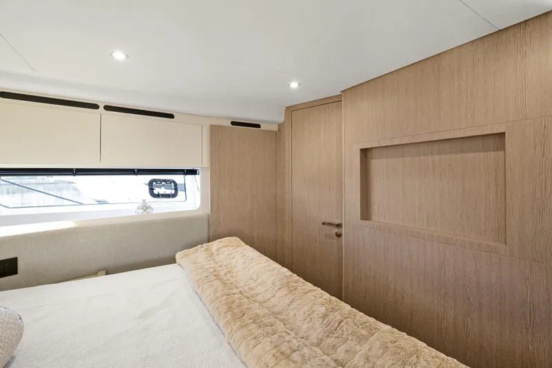 Guyal Yacht Photos Pics Luxurious interior of 2024 Azimut Fly 53 yacht bedroom with modern design and cozy bedding.