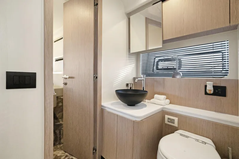 Guyal Yacht Photos Pics Luxurious bathroom interior of 2024 Azimut Fly 53 yacht with modern fixtures and elegant design.