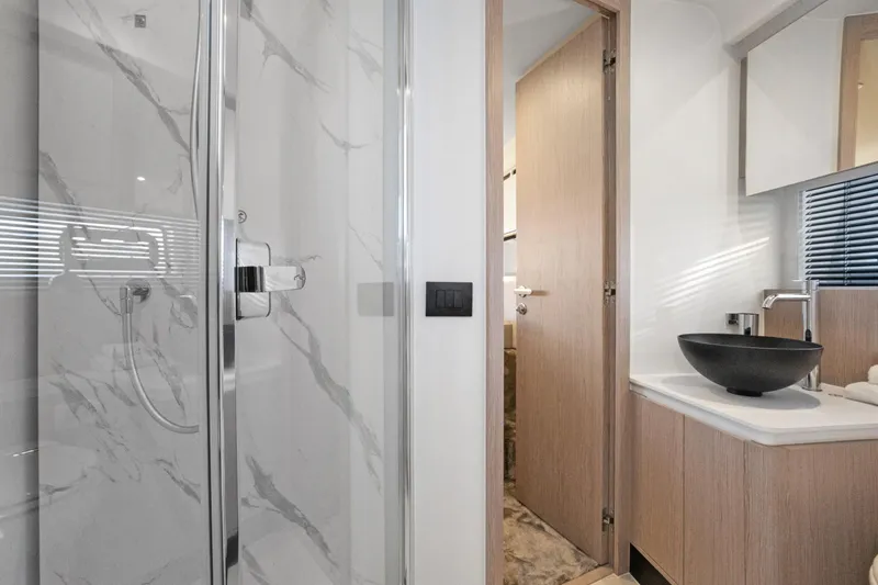 Guyal Yacht Photos Pics Luxurious bathroom in 2024 Azimut Fly 53 yacht with modern fixtures and marble accents.