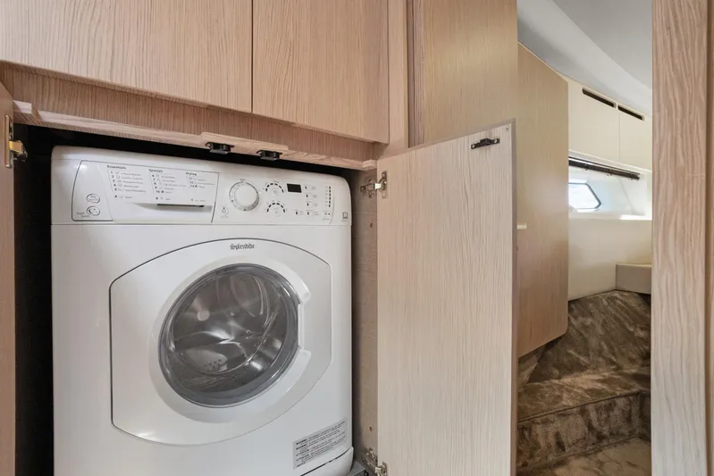Guyal Yacht Photos Pics Laundry area with washer in 2024 Azimut Fly 53 yacht interior.