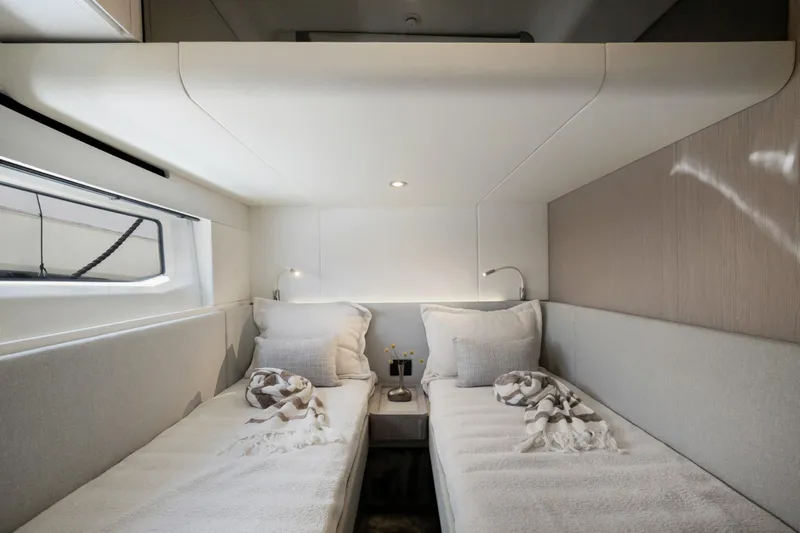 Guyal Yacht Photos Pics Luxurious twin cabin interior of 2024 Azimut Fly 53 yacht, featuring modern design and cozy bedding.