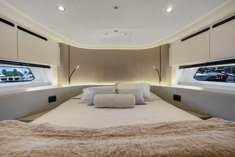 Guyal Yacht Photos Pics Luxurious bedroom interior of 2024 Azimut Fly 53 yacht with elegant bedding and modern lighting.