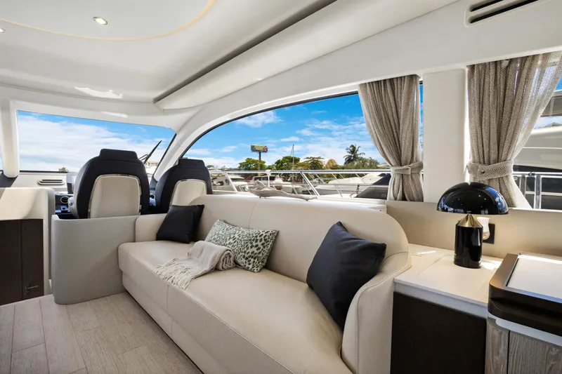 Guyal Yacht Photos Pics Luxurious interior of 2024 Azimut Fly 53 yacht with elegant seating and scenic window view.