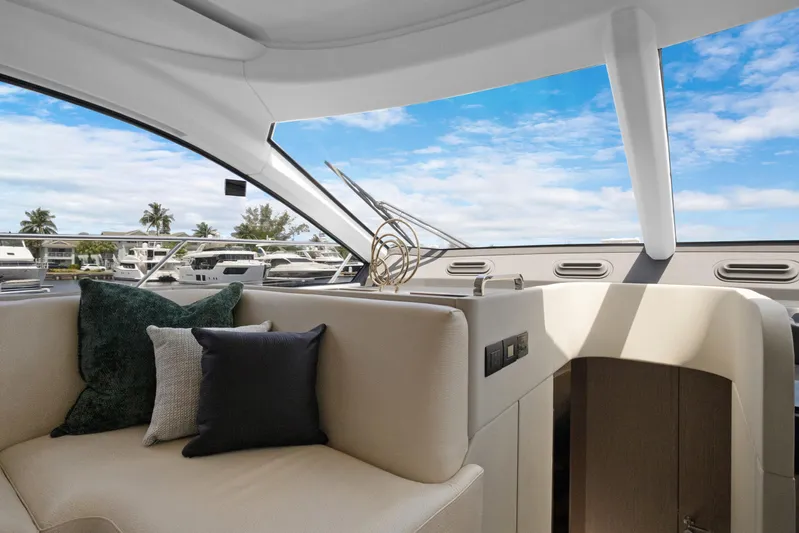 Guyal Yacht Photos Pics Interior of 2024 Azimut Fly 53 yacht with plush seating and scenic marina view.