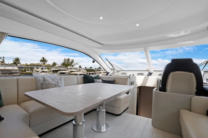 Guyal Yacht Photos Pics Luxurious interior of 2024 Azimut Fly 53 yacht with elegant seating and panoramic windows.