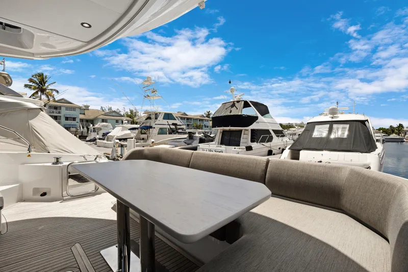 Guyal Yacht Photos Pics 2024 Azimut Fly 53 yacht interior with marina view, featuring elegant seating and table.