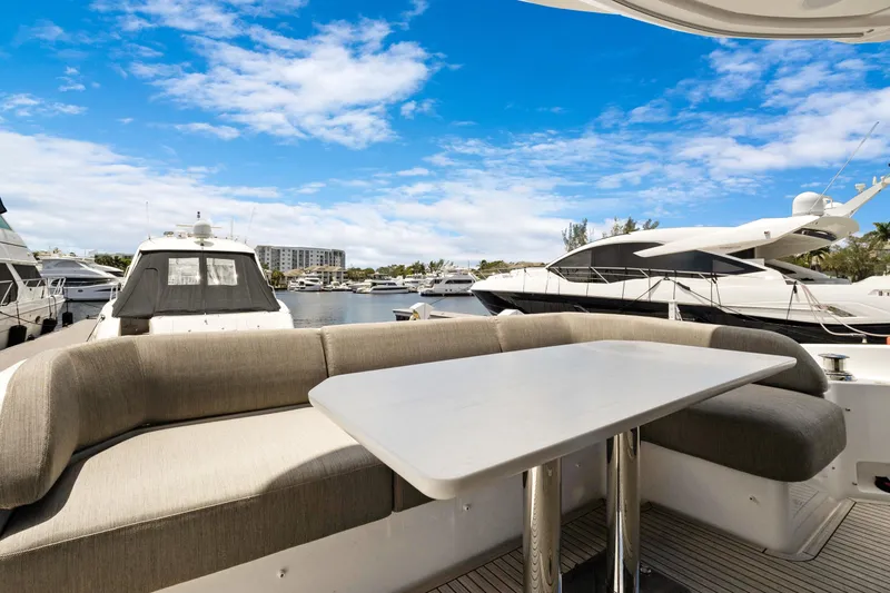 Guyal Yacht Photos Pics 2024 Azimut Fly 53 yacht with elegant seating, docked under a clear blue sky.