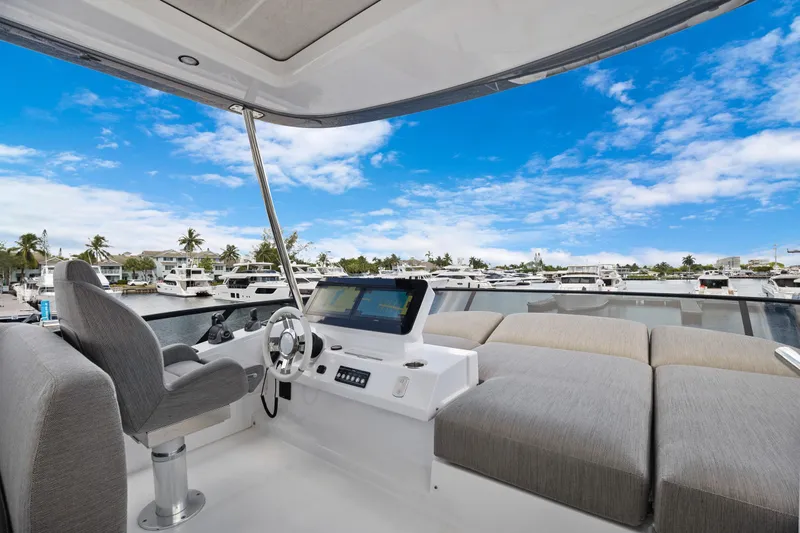 Guyal Yacht Photos Pics 2024 Azimut Fly 53 yacht helm with luxurious seating and marina view.