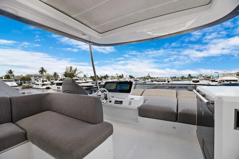 Guyal Yacht Photos Pics Luxurious 2024 Azimut Fly 53 yacht interior with plush seating and marina view.