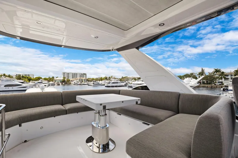 Guyal Yacht Photos Pics Luxurious 2024 Azimut Fly 53 yacht with elegant seating and marina view.