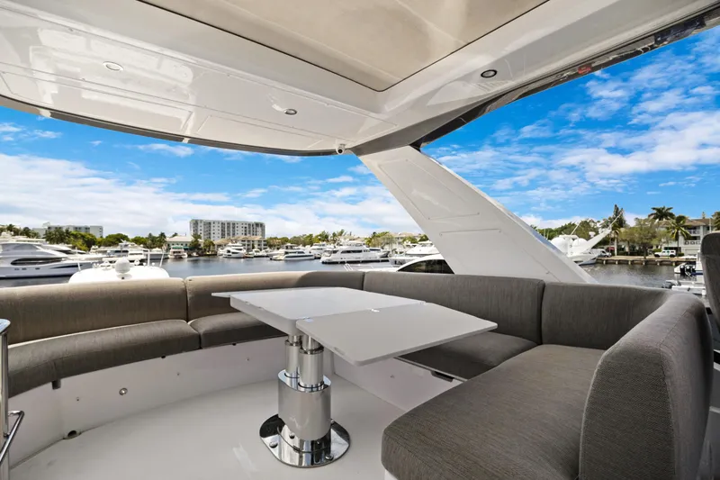 Guyal Yacht Photos Pics Luxurious 2024 Azimut Fly 53 yacht interior with elegant seating and marina view.