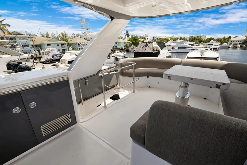 Guyal Yacht Photos Pics 2024 Azimut Fly 53 yacht deck with seating area and marina view.