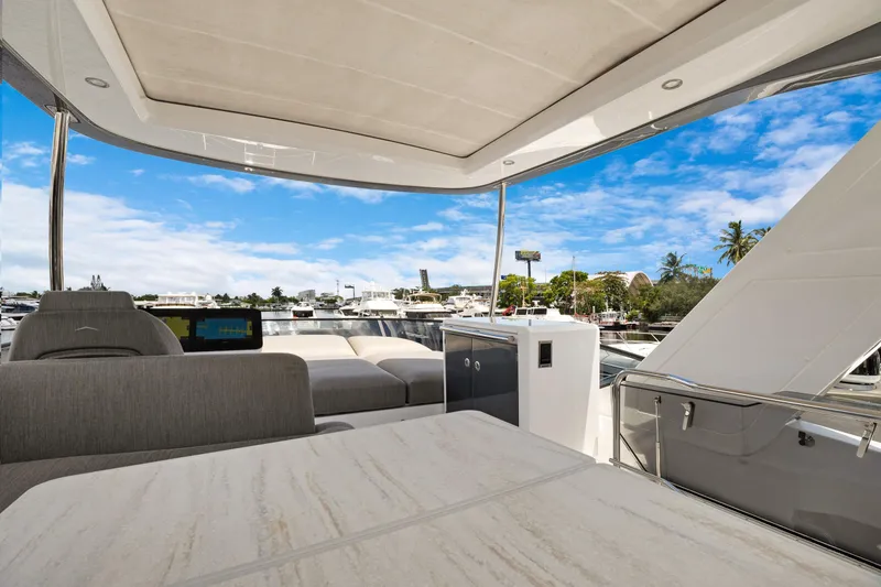 Guyal Yacht Photos Pics 2024 Azimut Fly 53 yacht deck with luxurious seating and marina view.