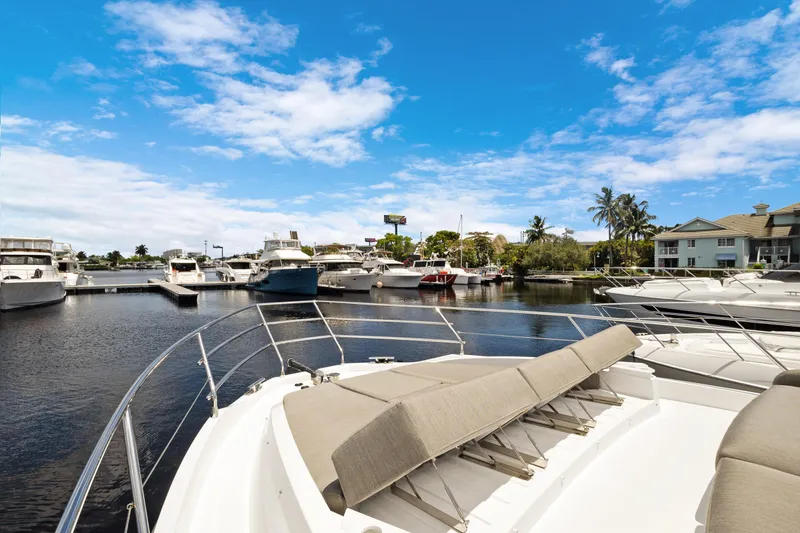 Guyal Yacht Photos Pics 2024 Azimut Fly 53 yacht docked in a sunny marina with clear blue skies.