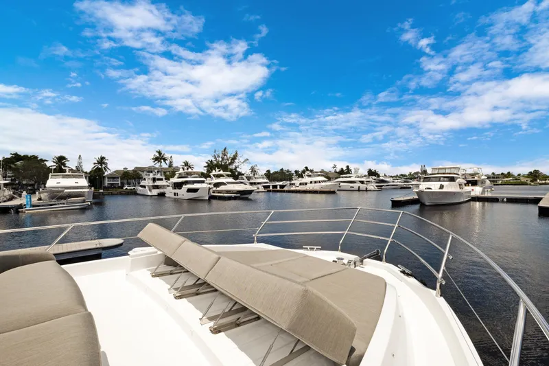 Guyal Yacht Photos Pics 2024 Azimut Fly 53 yacht docked in a marina under a clear blue sky.