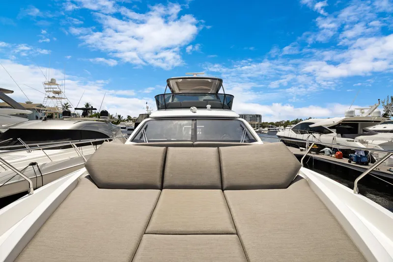 Guyal Yacht Photos Pics 2024 Azimut Fly 53 yacht with sunbed, docked under a clear blue sky.