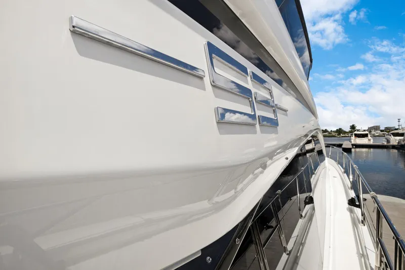 Guyal Yacht Photos Pics 2024 Azimut Fly 53 yacht side view with sleek design and marina backdrop.