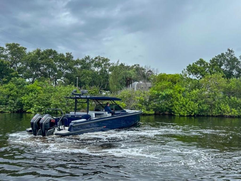 2024 BRABUS Shadow 1000 ST boat cruising on a river with lush greenery.