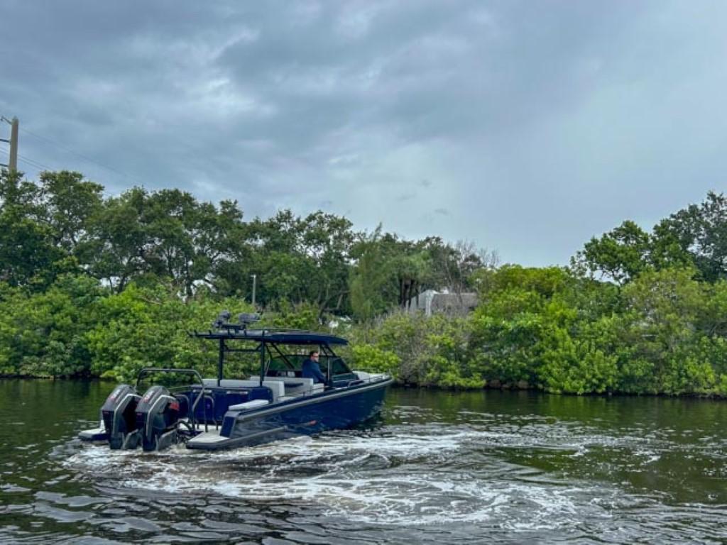 2024 BRABUS Shadow 1000 ST boat cruising on a river with lush greenery.