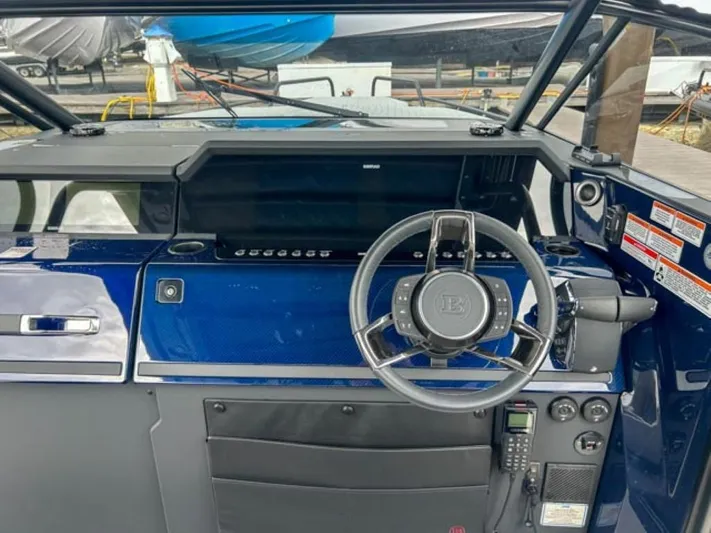  Yacht Photos Pics 2024 BRABUS Shadow 1000 ST boat dashboard with steering wheel and control panel.