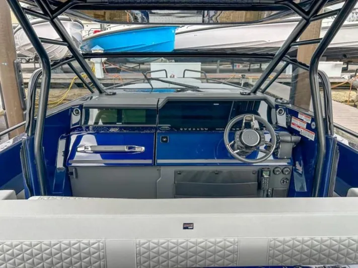  Yacht Photos Pics Cockpit of 2024 BRABUS Shadow 1000 ST luxury boat with blue dashboard and modern steering wheel.