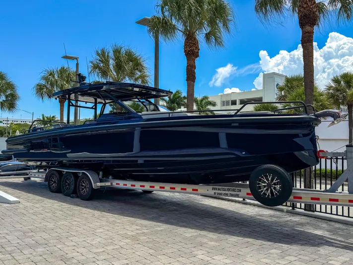  Yacht Photos Pics 2024 BRABUS Shadow 1000 ST boat on trailer, surrounded by palm trees.