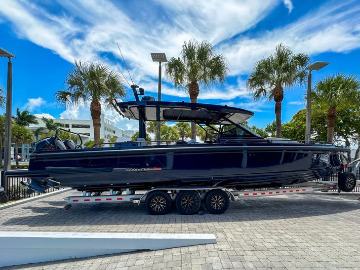  Yacht Photos Pics 2024 BRABUS Shadow 1000 ST boat on trailer, surrounded by palm trees.