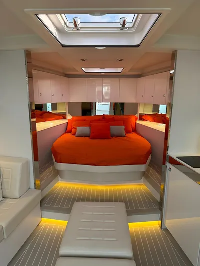  Yacht Photos Pics Luxurious interior of a 2018 VanDutch 55 yacht with vibrant orange bedding and modern design.