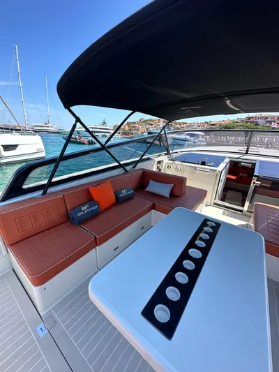  Yacht Photos Pics Luxurious 2018 VanDutch 55 yacht with spacious seating and elegant table, docked by the sea.