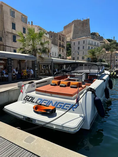  Yacht Photos Pics 2018 VanDutch 55 yacht docked in a scenic harbor with historic buildings.
