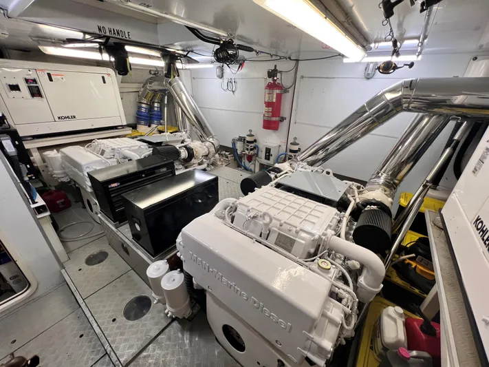 Slainte III Yacht Photos Pics Engine room of 2013 Custom Line Navetta yacht with Kohler generators and fire safety equipment.