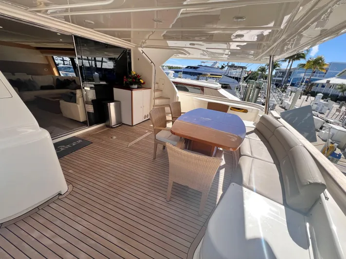 Slainte III Yacht Photos Pics Luxurious 2013 Custom Line Navetta yacht deck with seating and dining area.