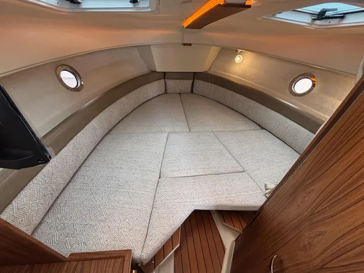  Yacht Photos Pics 2025 Ranger Tugs R-25 cabin interior with cozy seating and wooden accents.