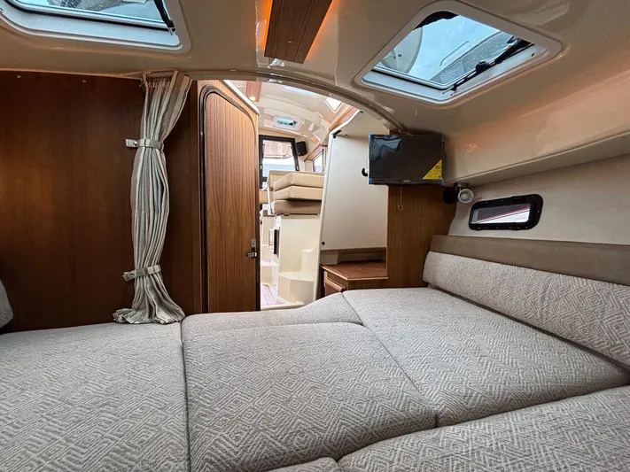  Yacht Photos Pics 2025 Ranger Tugs R-25 interior cabin with cozy bed, wood accents, and natural light.