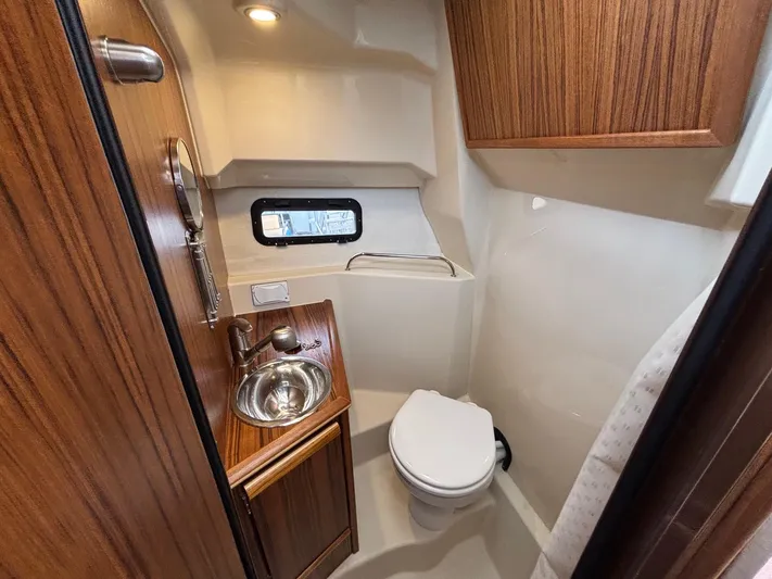  Yacht Photos Pics 2025 Ranger Tugs R-25 bathroom with wood accents, sink, and toilet.