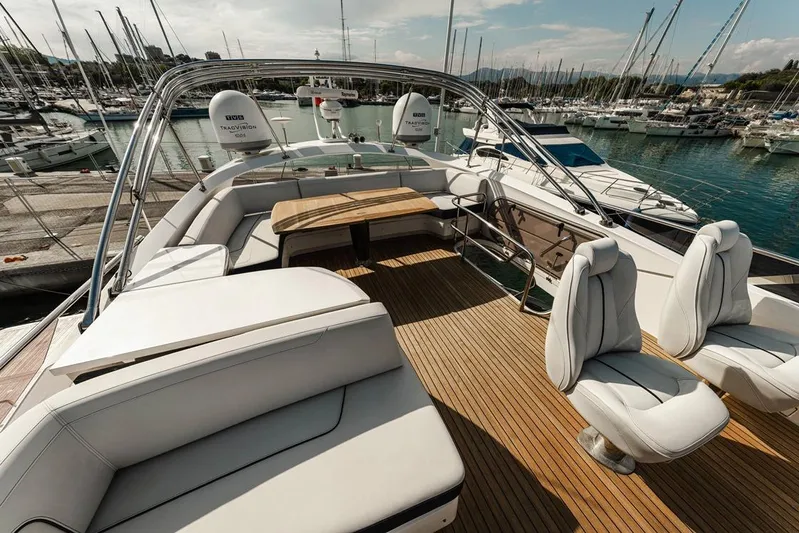  Yacht Photos Pics Luxurious 2014 Princess S72 yacht deck with seating and table, docked at marina.