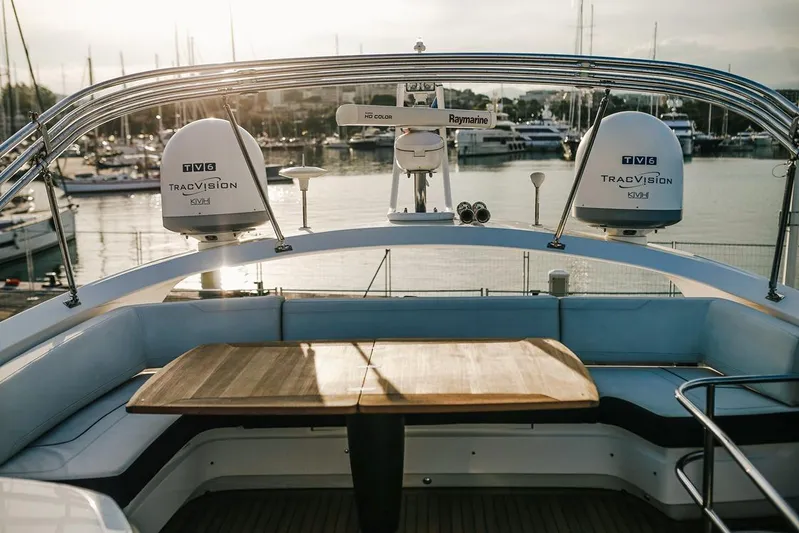  Yacht Photos Pics Flybridge of 2014 Princess S72 yacht with seating and table, overlooking marina.