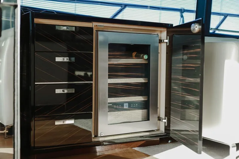  Yacht Photos Pics Luxurious yacht interior with sleek cabinetry and built-in wine cooler, Princess S72, 2014 model.