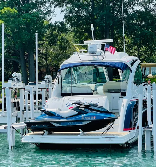 Our Seabatical Yacht Photos Pics 2014 Formula 45 Yacht docked with jet ski on platform, surrounded by trees.