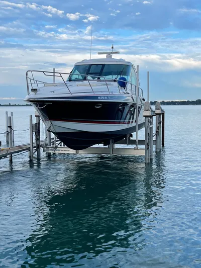 Our Seabatical Yacht Photos Pics 2014 Formula 45 Yacht on lift over calm water, under a partly cloudy sky.