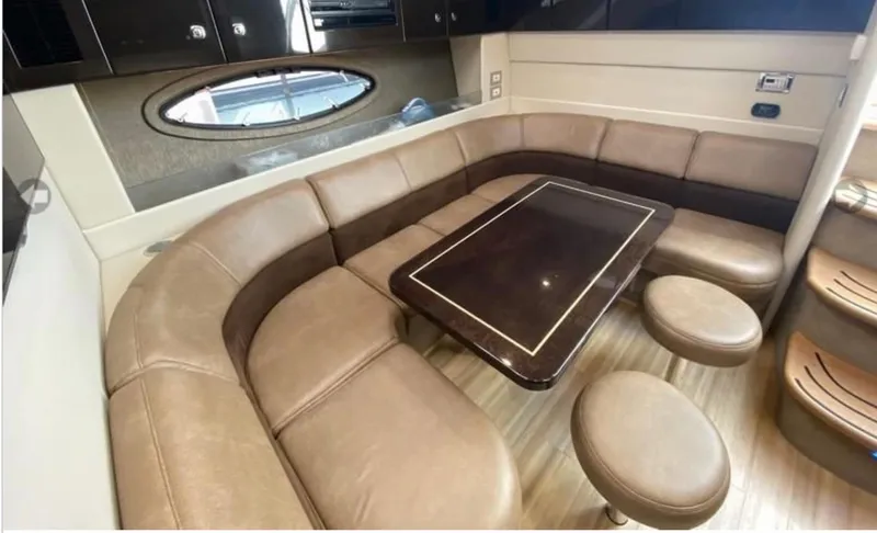 Our Seabatical Yacht Photos Pics Luxurious interior of a 2014 Formula 45 Yacht with leather seating and elegant table.
