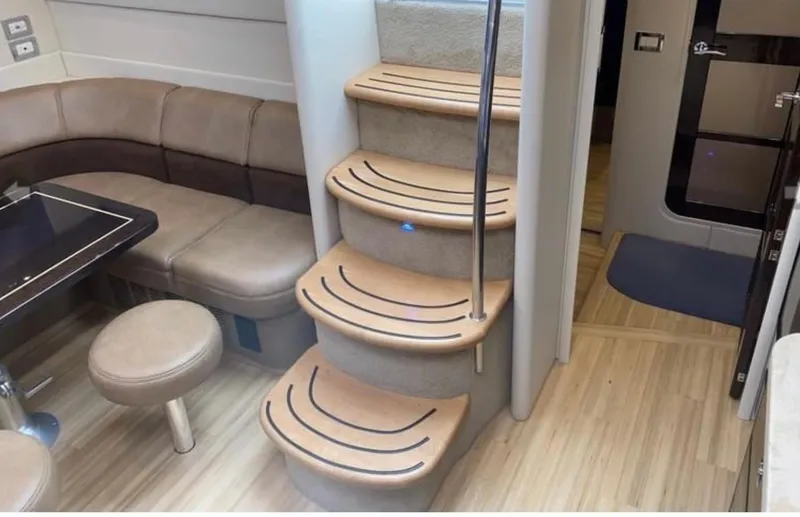 Our Seabatical Yacht Photos Pics Interior of 2014 Formula 45 Yacht with curved seating and wooden stairs.